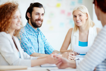 Group of young businesspeople having discussion of creative ideas at working meeting