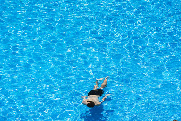 Fototapeta premium Children diving in a pool in summer