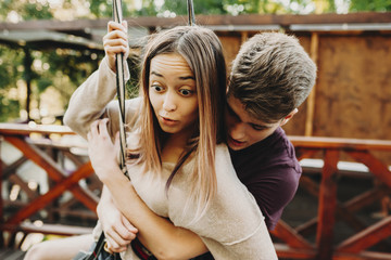Expressive young couple in zip line harness