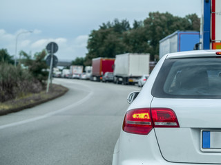Fototapeta na wymiar Rosalina, Italy - July, 11, 2018: traffic jam on a country road in Rosolina, Italy