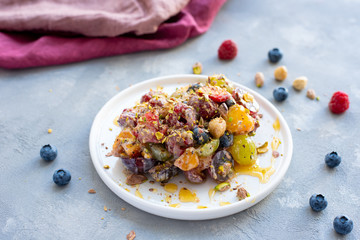 Colorful fruit salad with honey and poppy