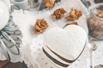 Sweet cookies in the form of hearts from gingerbread dough chocolate and a white glaze. Traditional cookies.