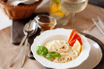 Lunch meal pasta withsmoked salmon and parmesan, served with glass of white wine