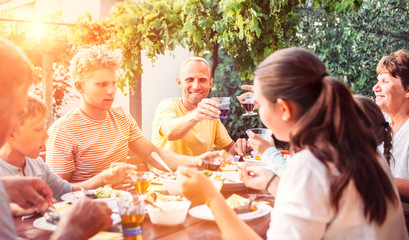 Big family have a dinner on open air in summer garden
