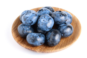 fresh ripe blueberry in wooden bowl isolated on white background