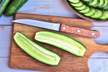 Fresh cucumber  slice along, on a cutting board.