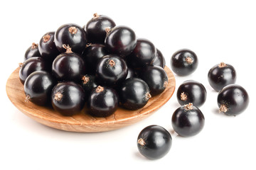 black currant in wooden bowl isolated on white background. Top view. Flat lay pattern