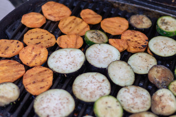 Aubergine, courgette and sweet potatoe slices on the grillage for barbecue