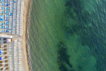 aerial view to beach with sun chairs and sea