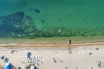 Fototapeta na wymiar aerial view to green sea and beach in summer day