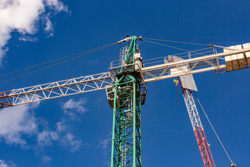 Construction site with cranes with blue sky
