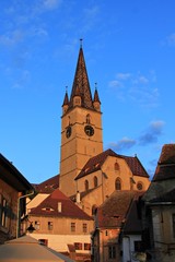 Fototapeta na wymiar Reformed / Evangelist church in sunset warm light. Medieval Sibiu, Romania 