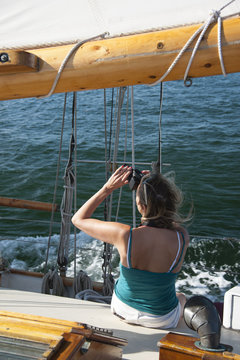 Woman Taking Photos on Old Wooden Schooner Sailboat