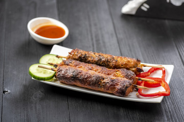 kebab on sticks served with vegetables