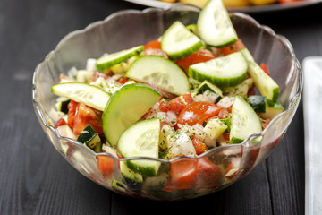 bowl with vegetable salad on a wooden table