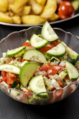 bowl with vegetable salad on a wooden table