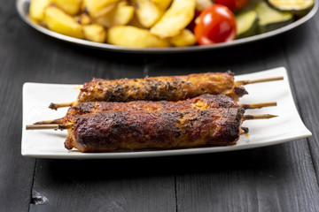 kebab on sticks served with vegetables