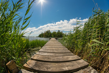 Beautiful sunshine, jetty at a lake © DZiegler