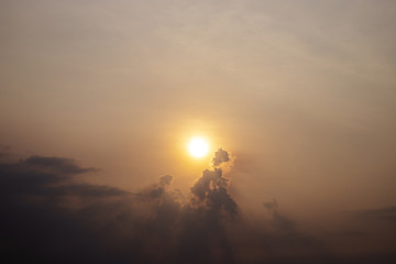 Orange sun on cloudy sky, morning sky landscape photo. Hot day morning with dusty sky. Orange sunrise.