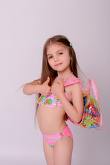 Naklejka premium Portrait of a cute little child girl in swimsuit.