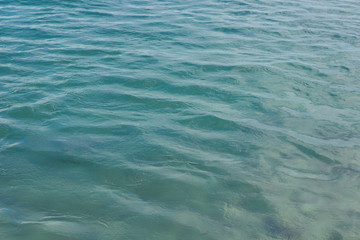 blue water surface background texture concept with small waves and empty space for copy or text