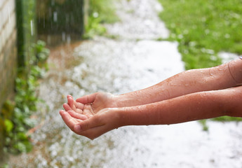 The child catches raindrops.