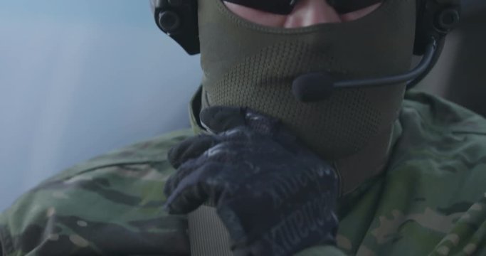 Special forces soldiers in a full combat uniform on a post in the woods