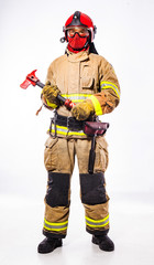 Man in suit of firefighter holding ax