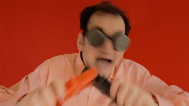 A crazy man carelessly connecting two electrical wires and receiving a harmful shock (electrocuted). Funny comedy shot. Version without effect graphics.
