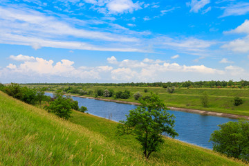 Fototapeta na wymiar View on the irrigation canal on summer