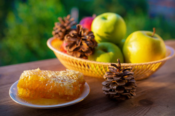Honeycombs and ripe apples on wooden background