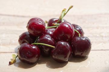 Pile of ripe cherry on wooden background