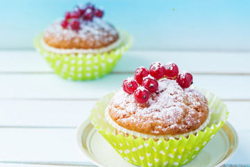 A festive dessert with red berries and powdered sugar. Cake with berries. Close-up. Copy space.