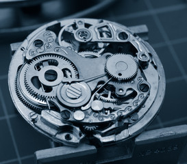 close up of watch machinnery displayed over technical board