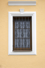 Fototapeta na wymiar A window with a lattice of an ancient building
