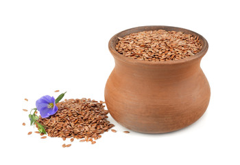 clay pot with flax seeds and flower isolated on white background. flaxseed or linseed. Cereals.