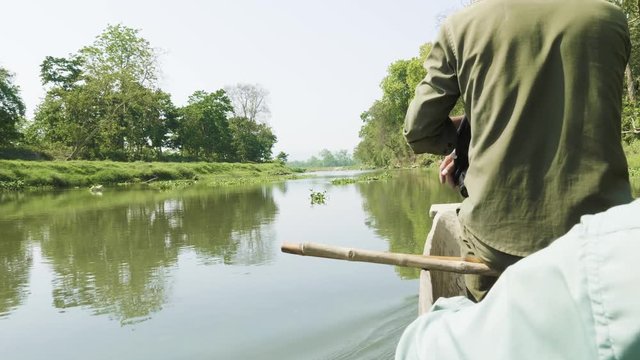 Canoeing in the river of rainforest in the national park Chitwan, Nepal.