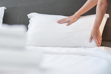 Hands Making Bed from Hotel Room Service