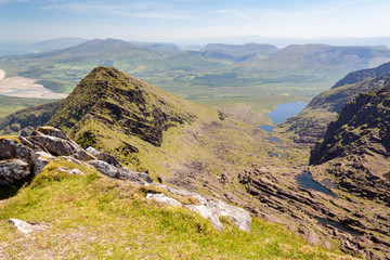 Summer view looking east along Faha Ridge and Pater Noster Lakes towards mountains of the Dingle Peninsula in County Kerry, Ireland