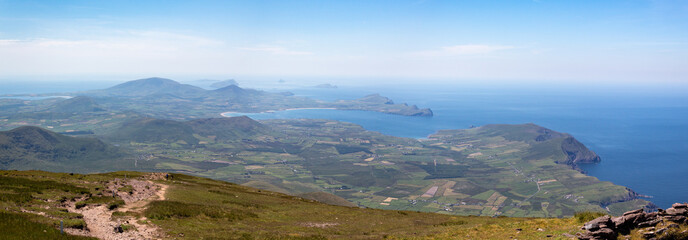Fototapeta premium Summer view looking west from summit of Mount Brandon towards Smerwick Harbour, Sybil Head and the Blasket Islands in County Kerry, Ireland.