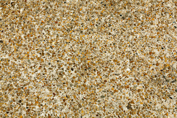 Pebble stone floor tile seamless background. Cement mixed gravel pebble stone floor texture. Wet round pebble stone rock floor in dramatic lighting.