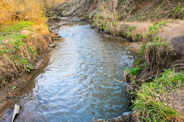 A calm flow of the Ramenka rivulet. Energizing spring sunlight awakens nature.