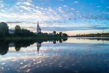 Fototapeta na wymiar Boundless sky over the Volga river in the early morning. Ancient Monastery of St.Catherine. City of Tver, Russia.