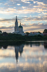 Fototapeta na wymiar Boundless sky over the Volga river in the early morning. Ancient Monastery of St.Catherine. City of Tver, Russia.
