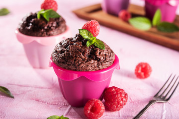 Sweet chocolate cupcake on pink background