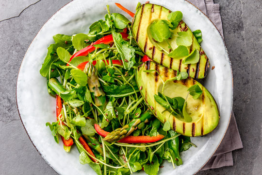 Green salad with grilled avicado. Top view