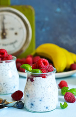 Vanilla yoghurt with raspberries and banana for breakfast. Dietary meals.