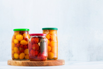 Harvest of red and yellow tomatoes, closed in cans for preservation and fermentation. Autumn...