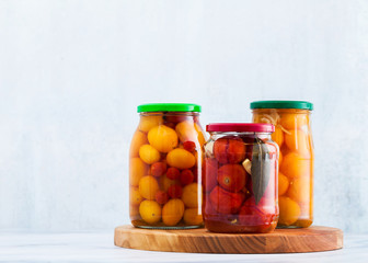 Harvest of red and yellow tomatoes, closed in cans for preservation and fermentation. Autumn preparations for wintering
