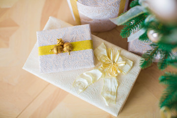 Fototapeta na wymiar Two luxurious gifts in white boxes wrapped in yellow ribbon with acorns
